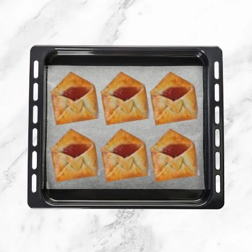 Baked Strawberry Jam-Filled Love Letter Pastries on a baking tray.