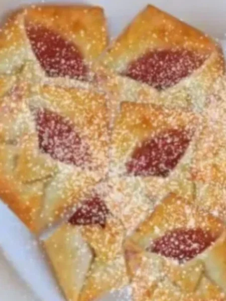 Love letter pastry with strawberry filling and powdered sugar.